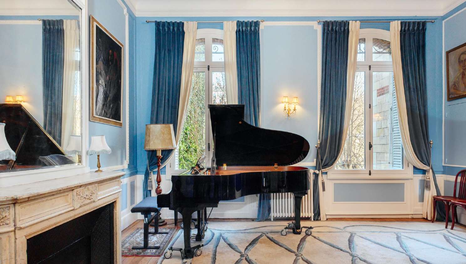 Salon Bleu, an intimate sky-blue room with a grand piano