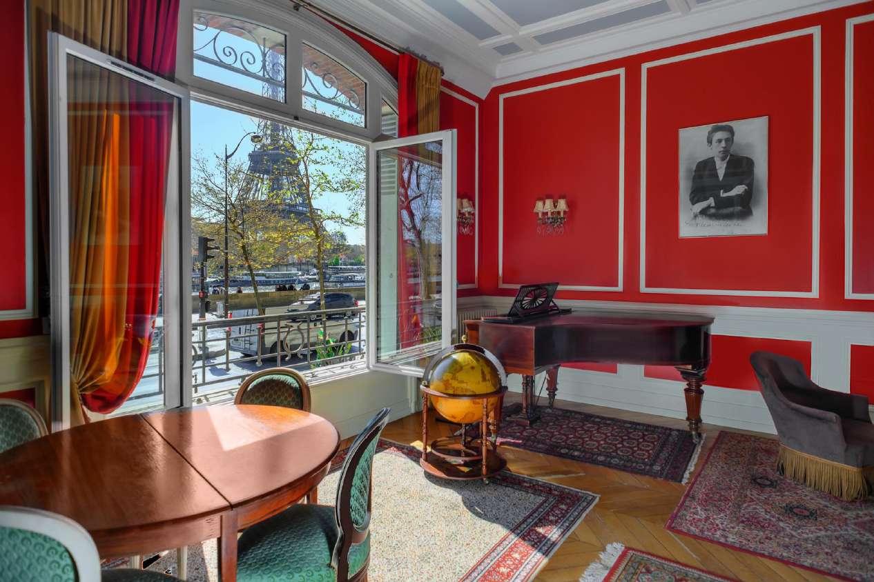 Salon Rouge with a grand piano and an arched window overlooking the Eiffel Tower, Conservatoire Rachmaninoff